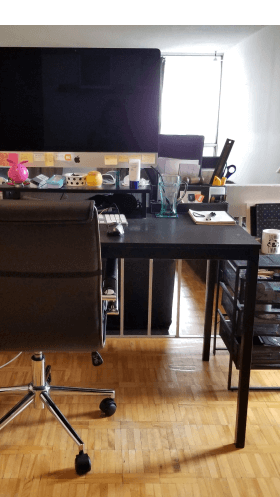 Desk space with monitor,  ergonomic office chair and set of drawers